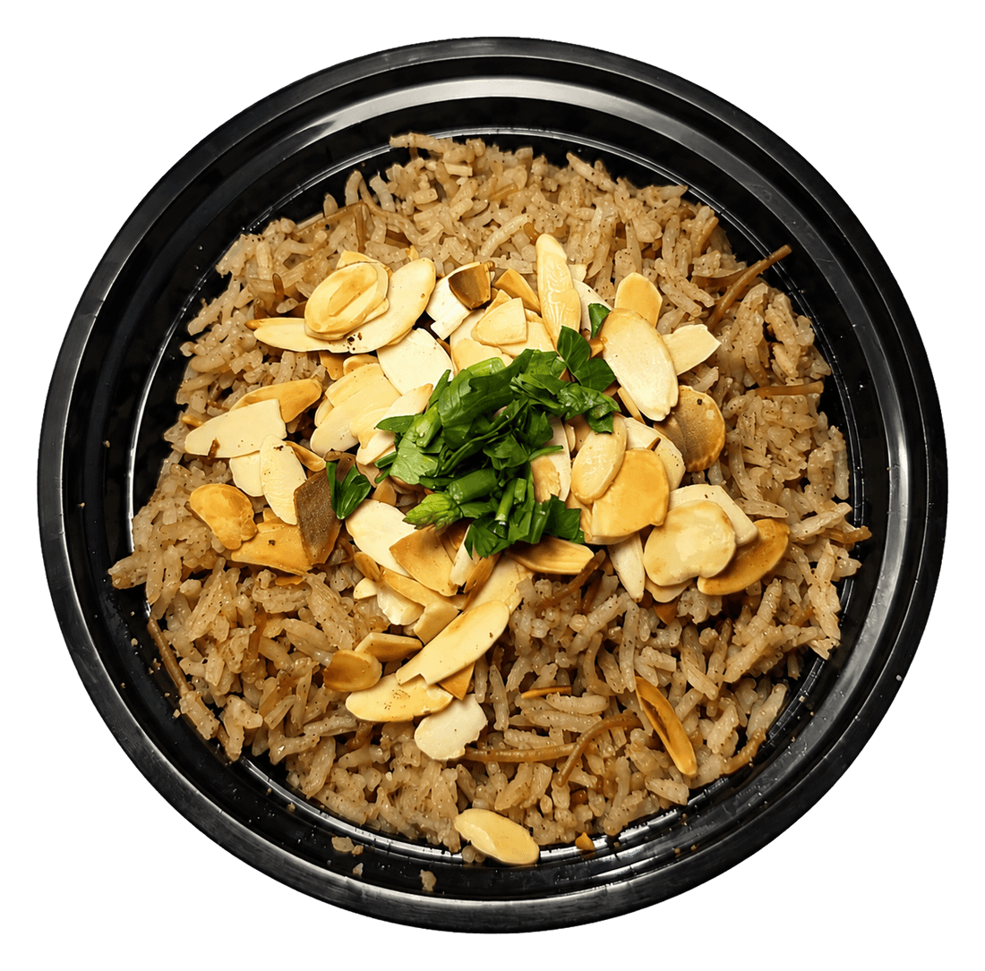Black bowl of rice topped with sliced toasted almonds and chopped parsley, seen from above.